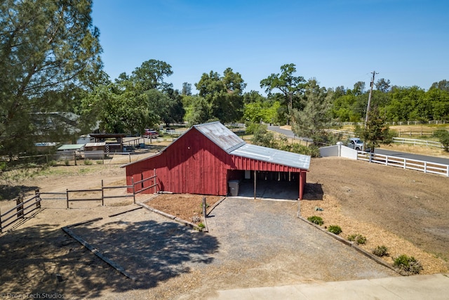 view of outdoor structure with a rural view