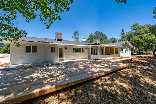 rear view of house with a wooden deck