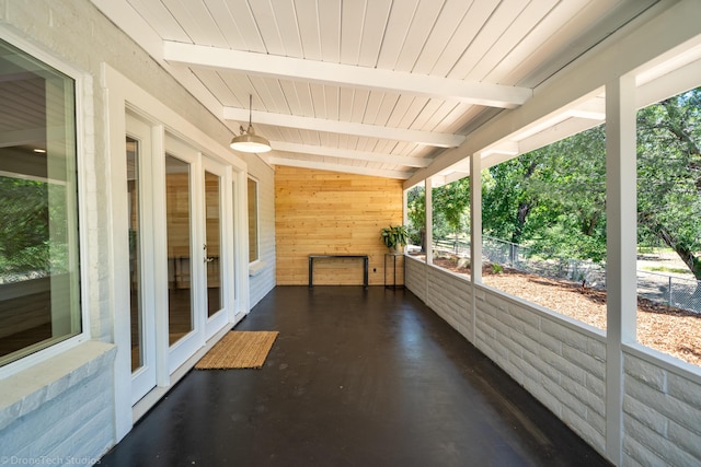 unfurnished sunroom with wood ceiling and beam ceiling