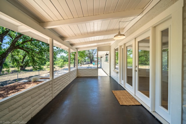 unfurnished sunroom with wooden ceiling and beam ceiling