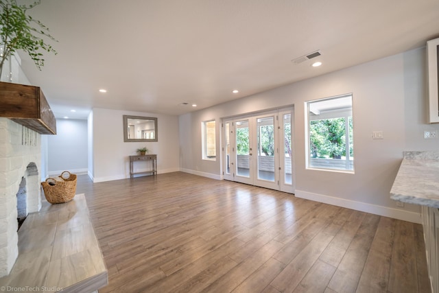 unfurnished living room with hardwood / wood-style flooring