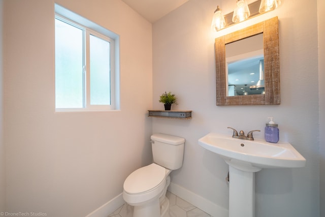 bathroom featuring sink, tile patterned floors, and toilet