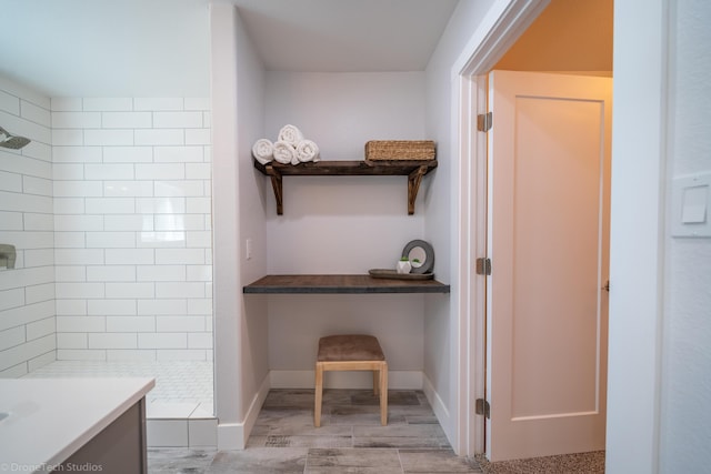 bathroom with vanity and tiled shower