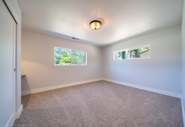 unfurnished room featuring carpet floors