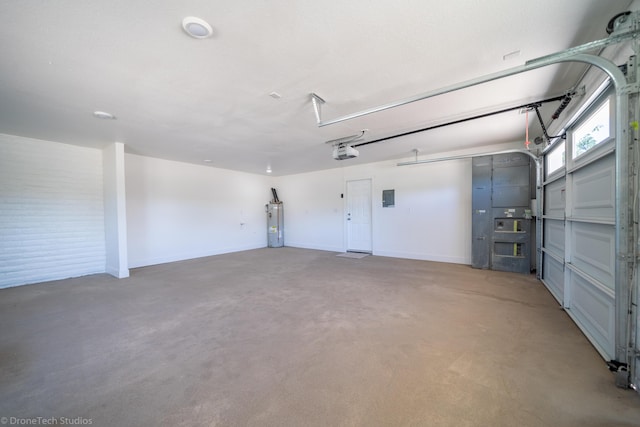 garage featuring a garage door opener and electric water heater