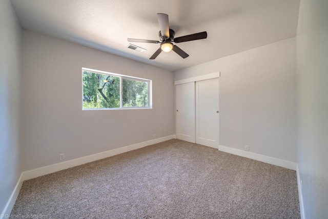 unfurnished bedroom with carpet floors, ceiling fan, and a closet