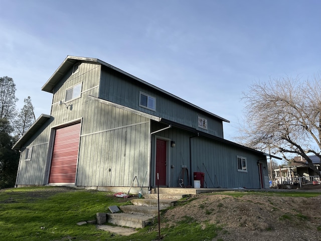 rear view of property featuring a lawn