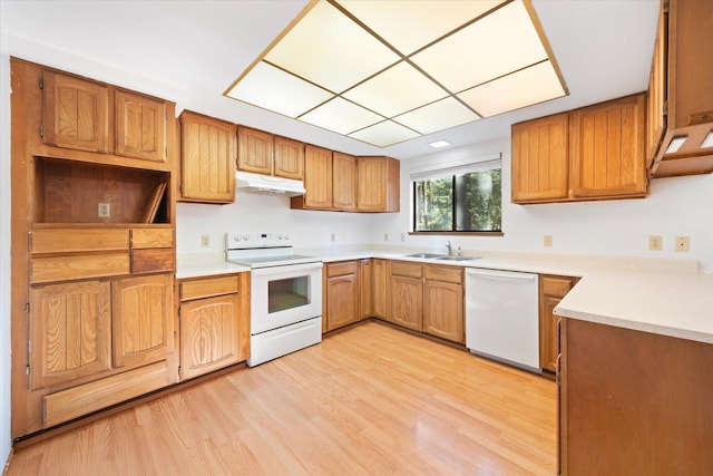 kitchen with light wood-type flooring, sink, and white appliances