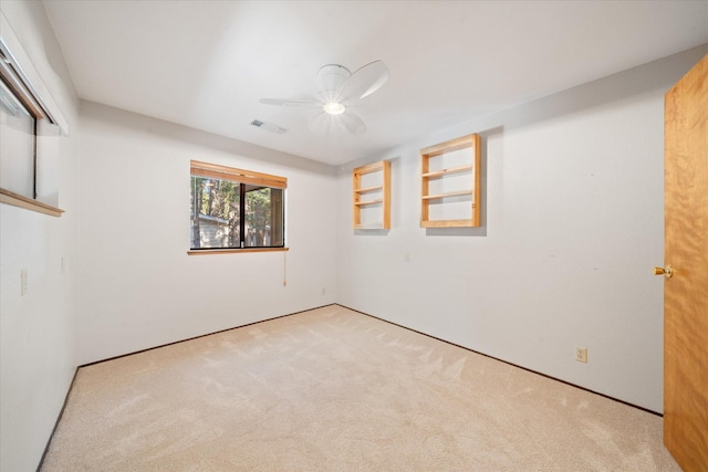 unfurnished room with ceiling fan and light carpet