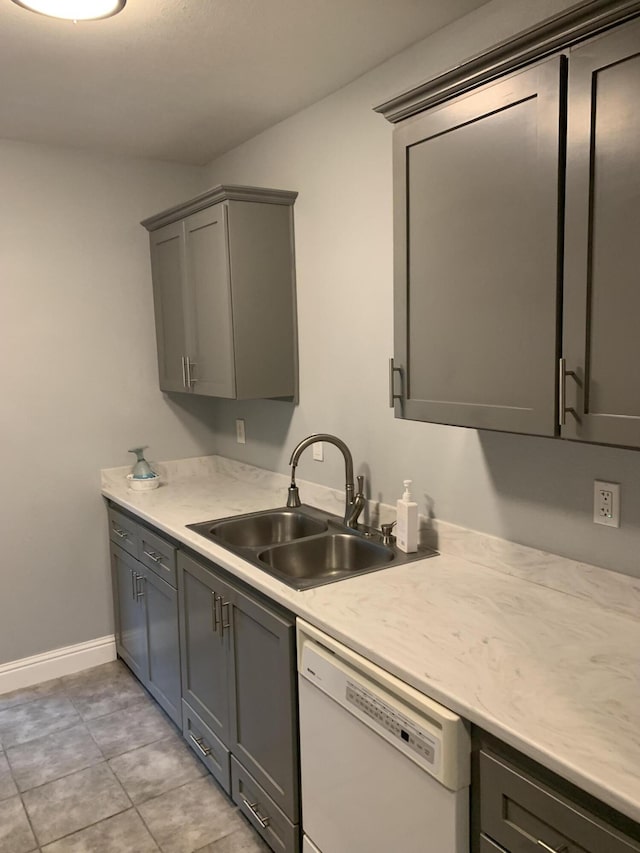 kitchen with dishwasher, sink, and gray cabinetry