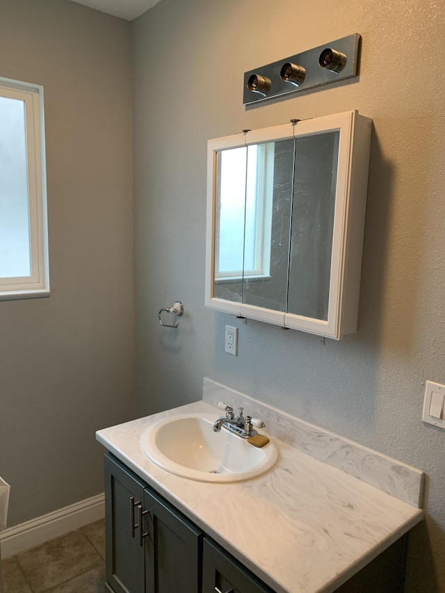 bathroom with tile patterned floors and vanity