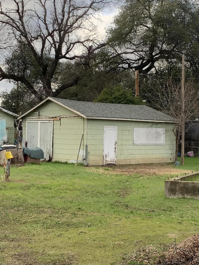 view of outdoor structure featuring a lawn