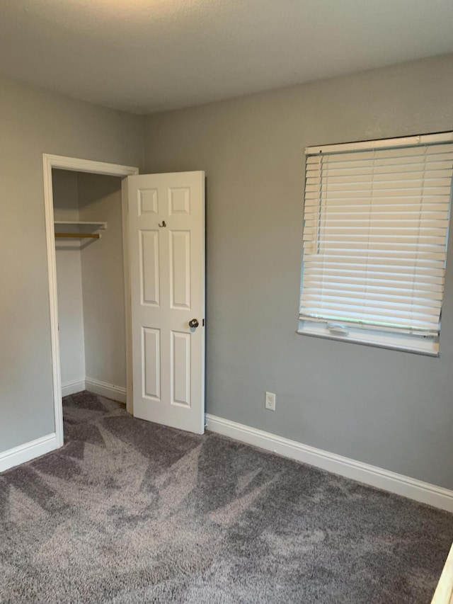 unfurnished bedroom featuring carpet floors and a closet