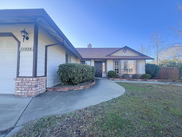 view of front facade with a garage and a front lawn