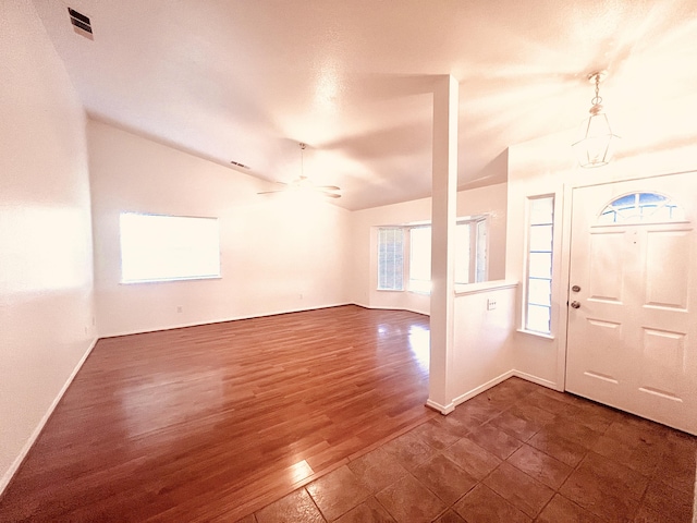 entryway with dark hardwood / wood-style flooring, vaulted ceiling, and ceiling fan