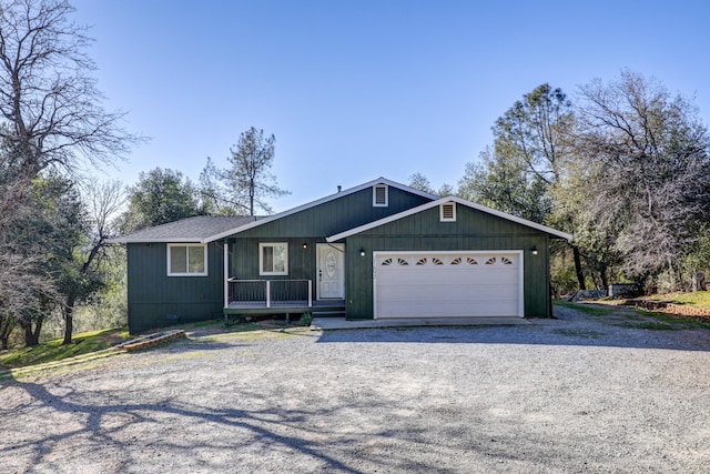 ranch-style house with a porch and a garage