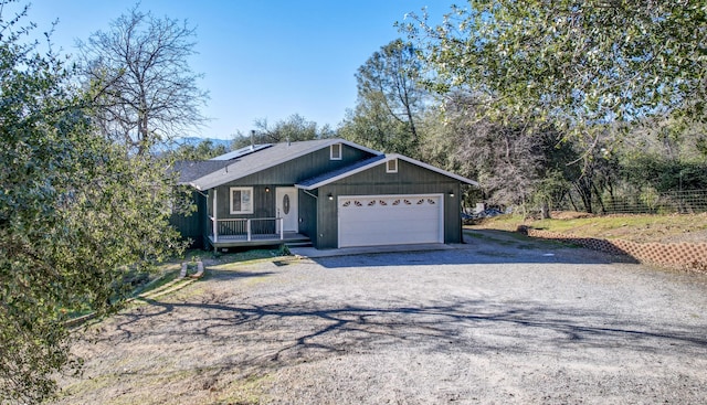 view of front of house featuring a garage and solar panels