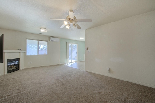 unfurnished living room with ceiling fan, a wall mounted AC, light carpet, and a textured ceiling