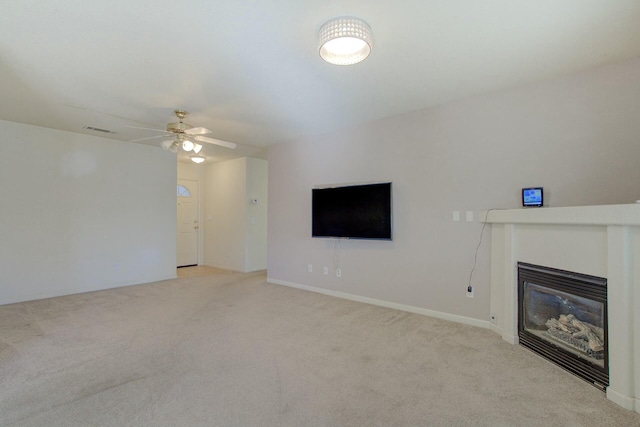 unfurnished living room featuring light carpet and ceiling fan