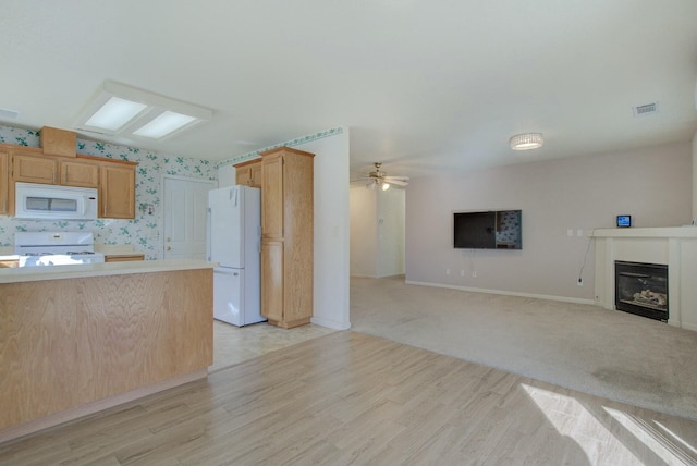 kitchen with ceiling fan, white appliances, and light brown cabinets