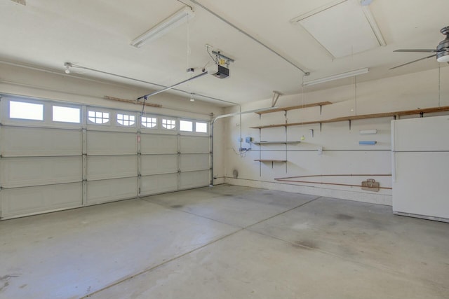 garage with a garage door opener and white refrigerator