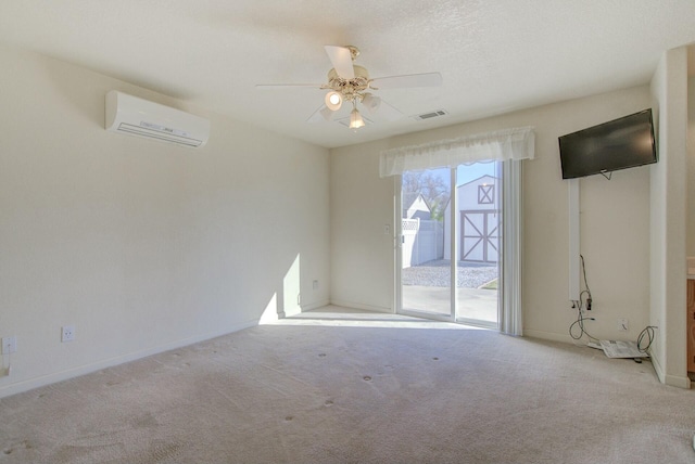 carpeted empty room with a wall mounted air conditioner and ceiling fan