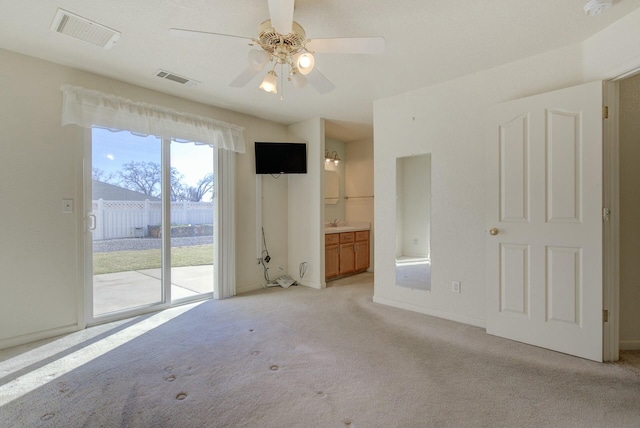 spare room featuring ceiling fan, light colored carpet, and sink