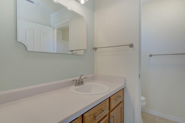 bathroom featuring vanity, toilet, and tile patterned flooring