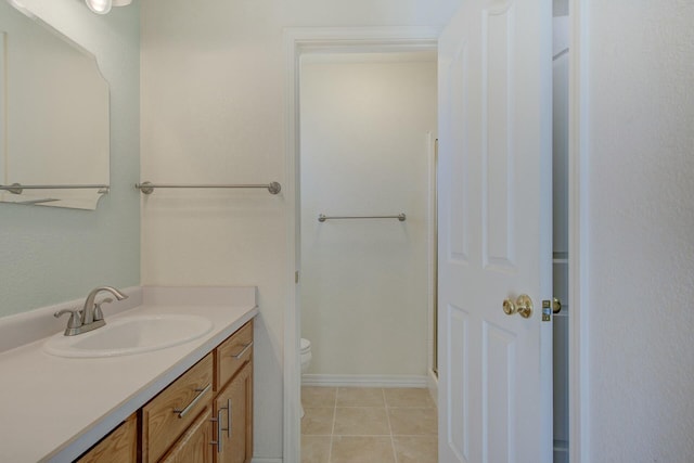 bathroom featuring vanity, toilet, and tile patterned flooring