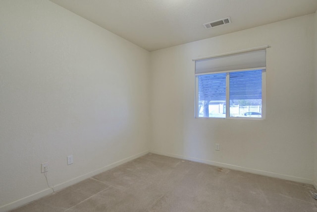 unfurnished room with light colored carpet