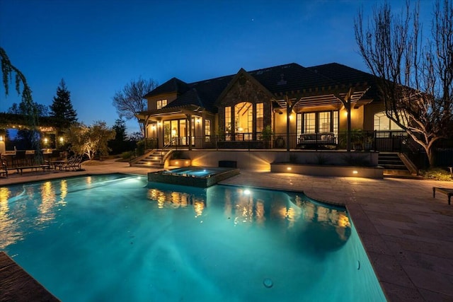 view of pool featuring a patio area and an in ground hot tub