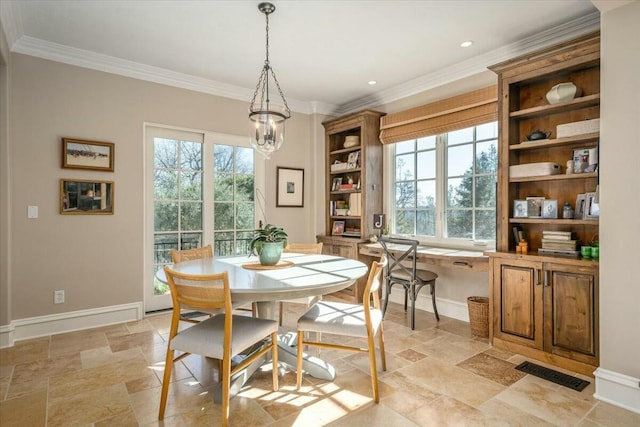 dining space with ornamental molding and a chandelier