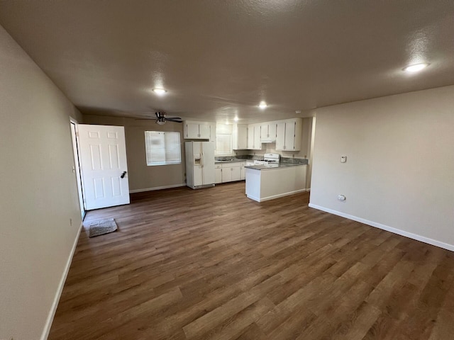 unfurnished living room featuring a textured ceiling, dark hardwood / wood-style floors, and ceiling fan