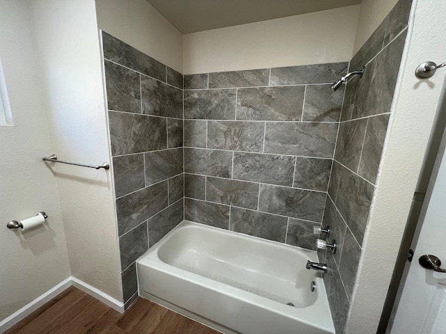 bathroom featuring tiled shower / bath and wood-type flooring