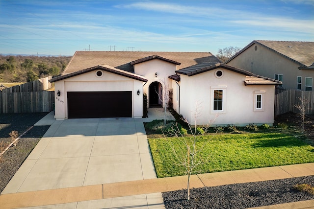 view of front of home featuring a garage and a front yard