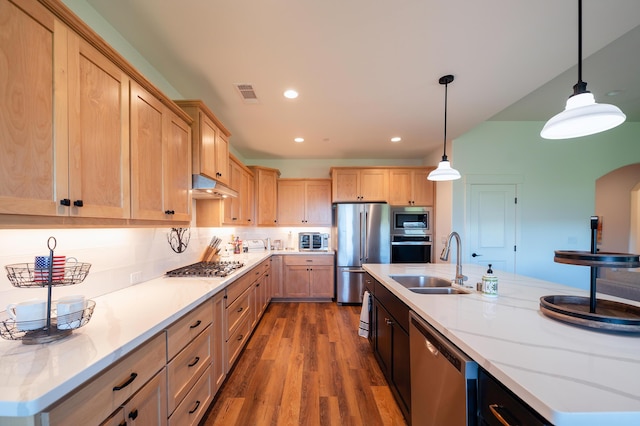 kitchen featuring pendant lighting, sink, appliances with stainless steel finishes, wood-type flooring, and light brown cabinetry