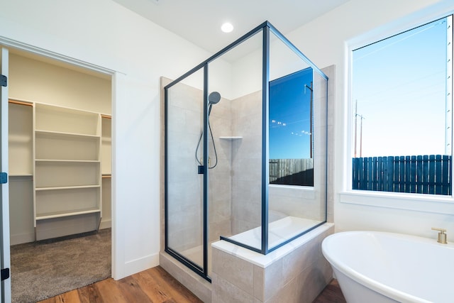 bathroom with separate shower and tub and hardwood / wood-style floors