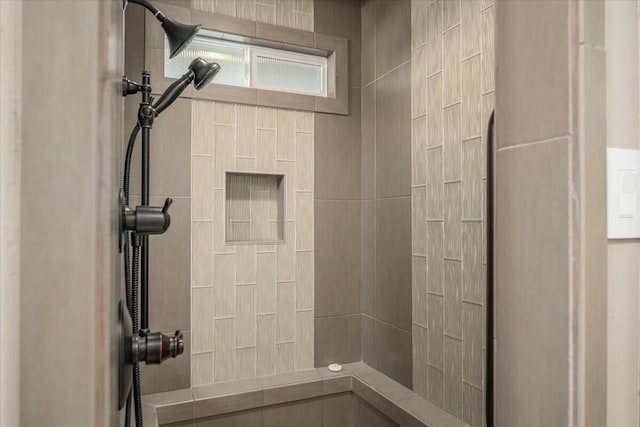 bathroom with tiled shower