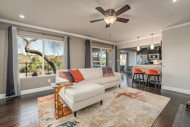 living room with ornamental molding, dark hardwood / wood-style floors, and ceiling fan