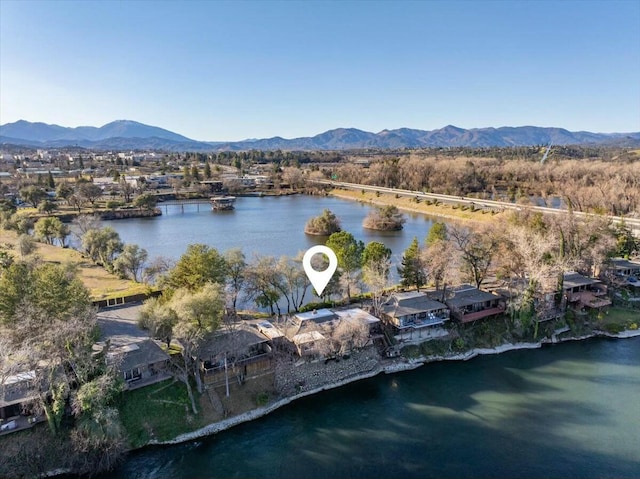 birds eye view of property with a water and mountain view