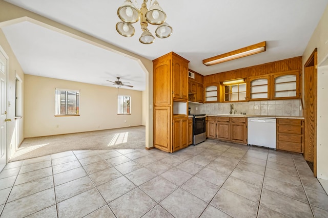 kitchen with light tile patterned flooring, tasteful backsplash, dishwasher, stainless steel electric stove, and ceiling fan with notable chandelier