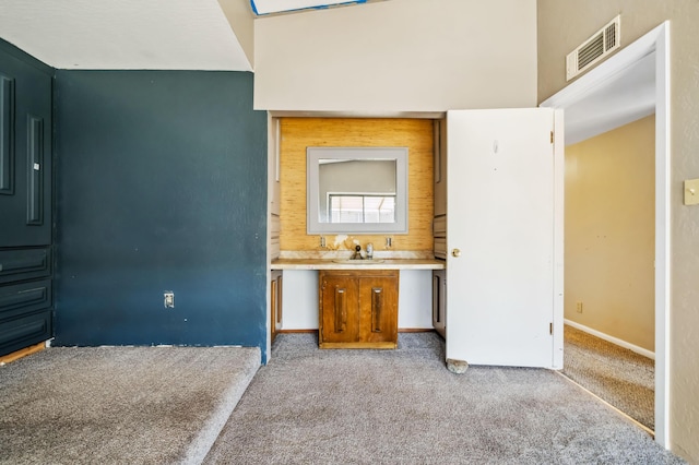 unfurnished bedroom featuring sink and light colored carpet