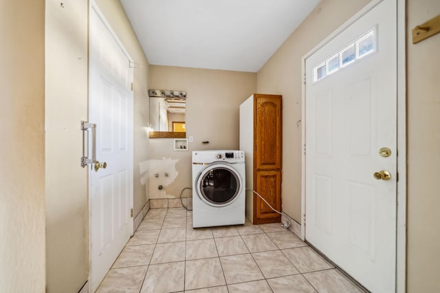 clothes washing area with washer / clothes dryer and light tile patterned floors