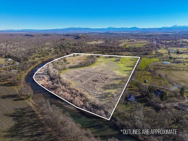 drone / aerial view featuring a mountain view