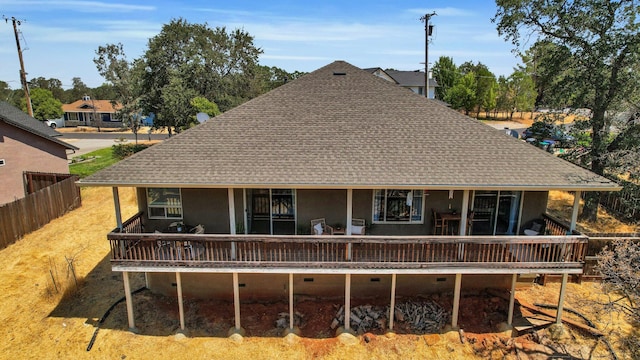 back of property with a wooden deck