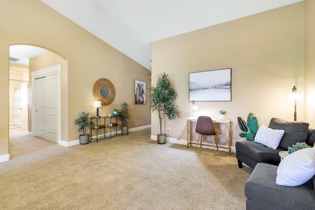 interior space with vaulted ceiling and light colored carpet