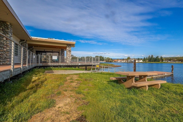 view of yard featuring a water view and a dock