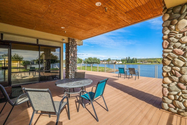 wooden terrace featuring a water view