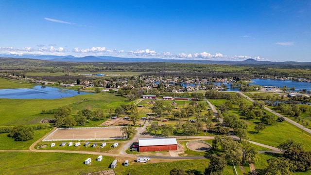 drone / aerial view with a water and mountain view