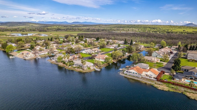 birds eye view of property featuring a water and mountain view